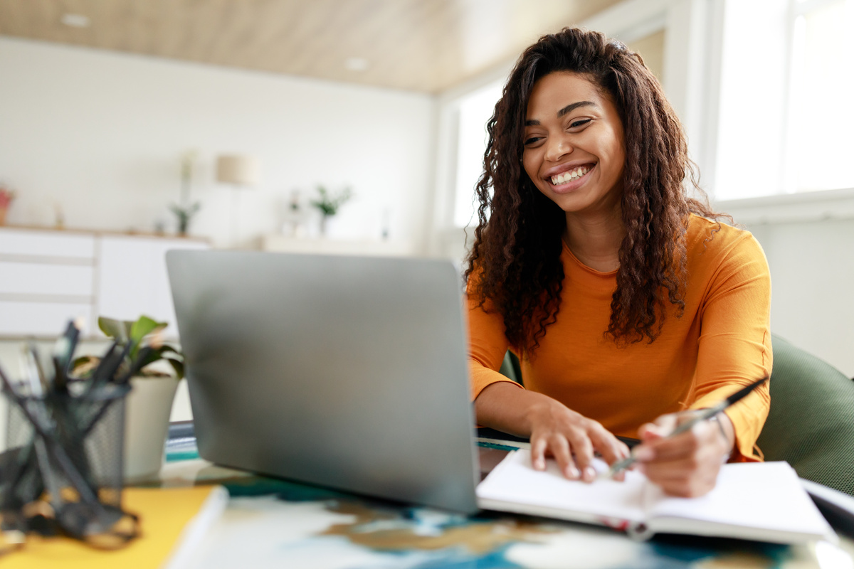Student at home with notebook and laptop-1200x800