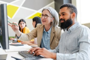 Educators collaborating on computer