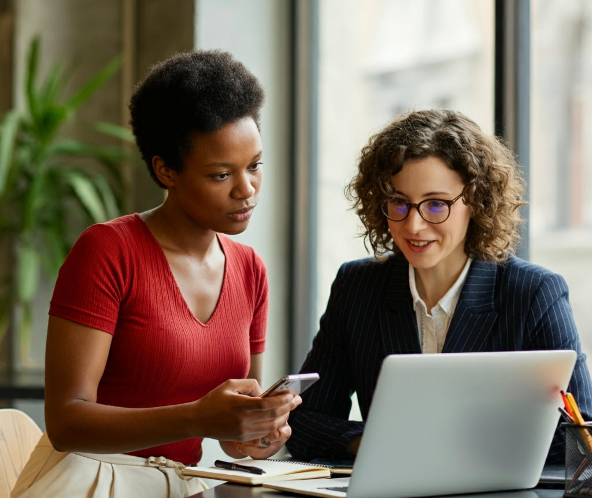 two-women-are-sitting-table-with-laptop-laptop two-women-are-sitting-table-with-laptop-laptop