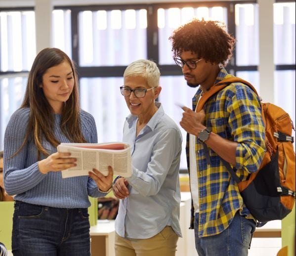 Advisor helping two students