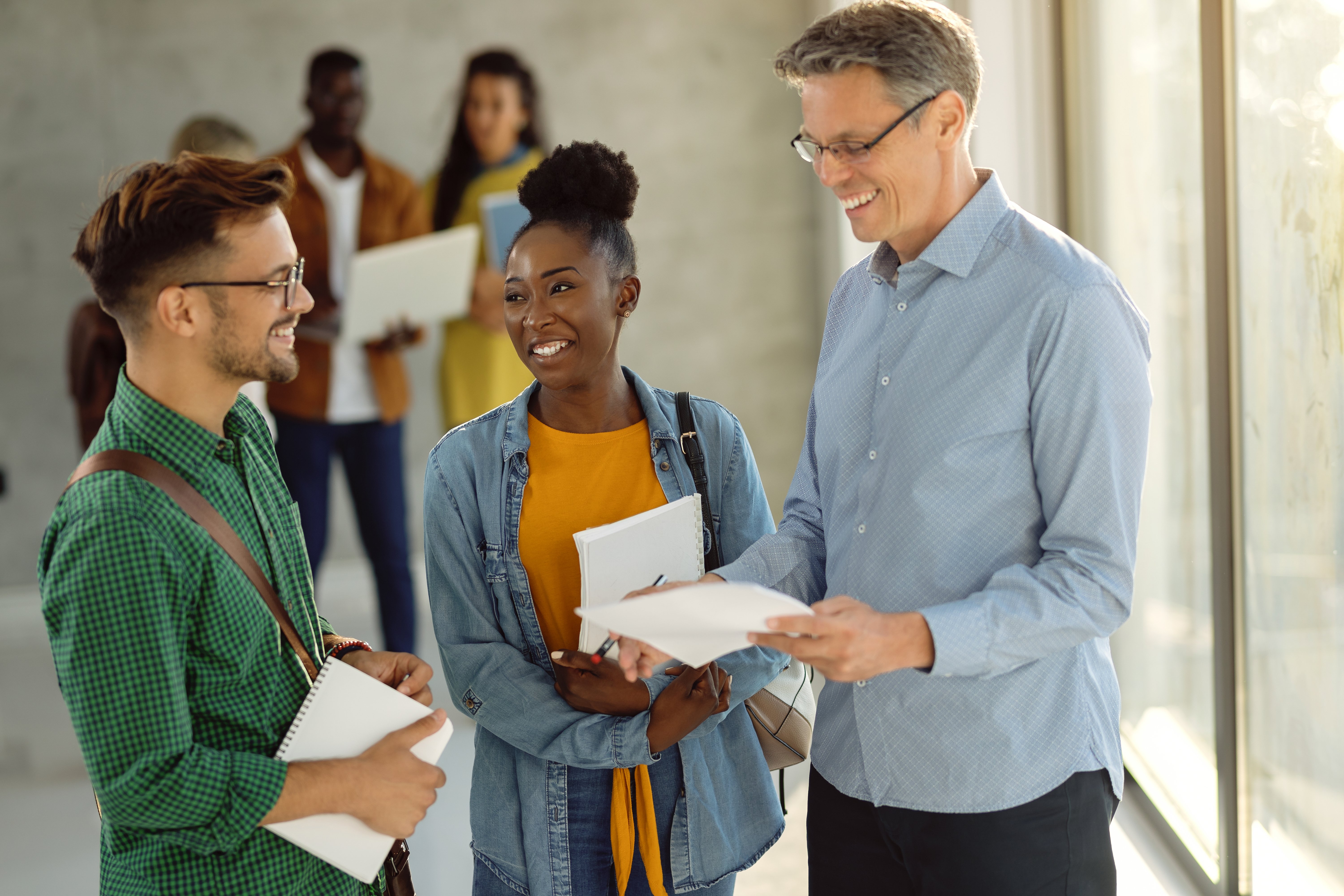Advisor and students discussing in hallway