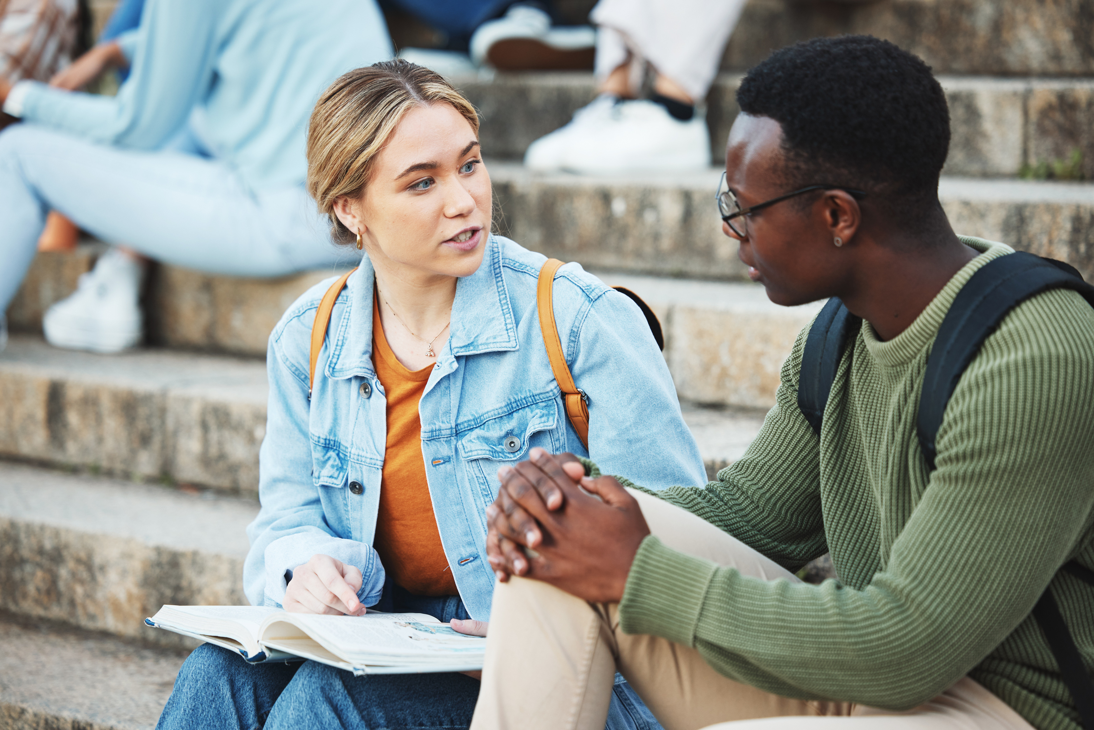 talking-students-black-man-woman-stairs-university-steps-college-campus-bleachers-studying-research-books-friends-people-notebook-education-learning-school-exam-preparation